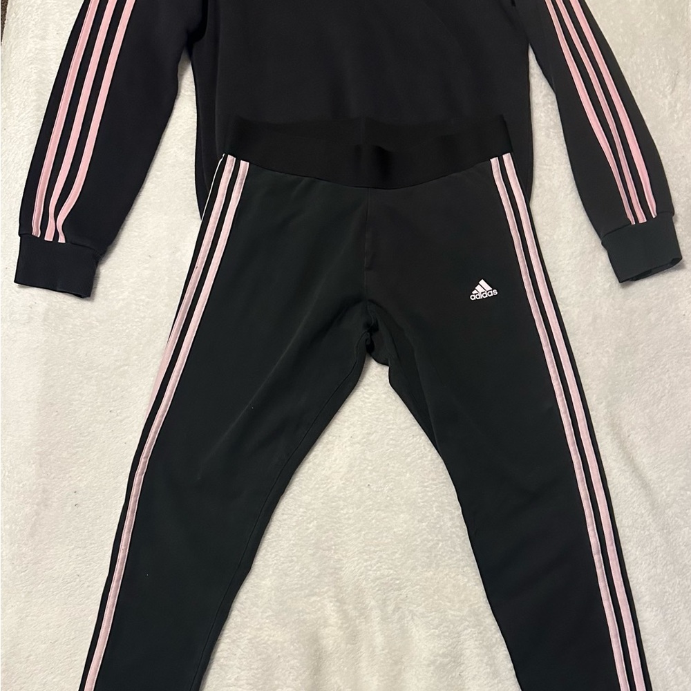 Adidas Women’s Black Joggers with Pink Stripes.
Medium top and bottom.
